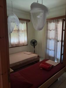 a bedroom with two beds and two windows at Enjoy The Silence in Svoronata +137 photos