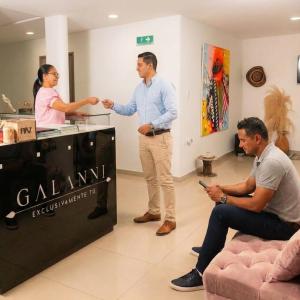 two men and a woman standing in a room at Apartaestudios Galanni in Valledupar