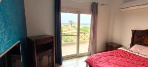 a bedroom with a bed and a view of the ocean at El Ain El Sokhna-Villa at Piacera Resort Seaview in Ain Sokhna +29 photos