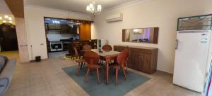 a kitchen and dining room with a table and chairs at El Ain El Sokhna-Villa at Piacera Resort Seaview in Ain Sokhna