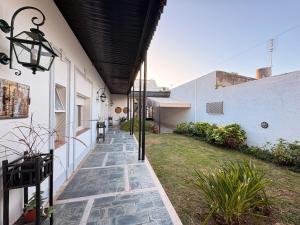a hallway of a house with a stone walkway at Casa LUHA in San Antonio de Areco