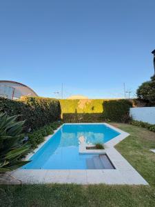 a swimming pool in the middle of a yard at Casa LUHA in San Antonio de Areco