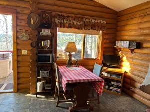 a dining room with a table and a window at Montana Hill Guest Ranch in Bridge Lake