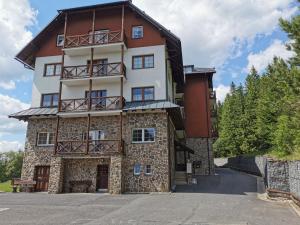 a large building with balconies on the side of it at Rodinný Špic in Špičák