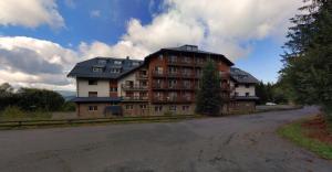 a large apartment building on the side of a road at Rodinný Špic in Špičák +6 photos