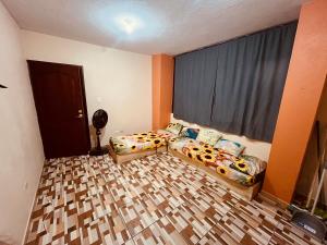 a bedroom with two beds and a window at Apt 1 in Tena