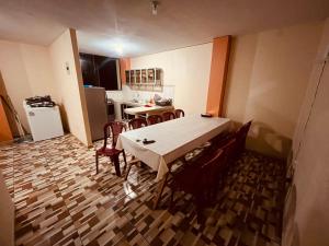 a room with a table and chairs and a kitchen at Apt 1 in Tena