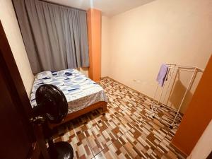 a small bedroom with a bed and a window at Apt 1 in Tena