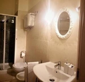 a bathroom with a sink and a toilet and a mirror at Sui Passi di Francesco in Valfabbrica +90 photos