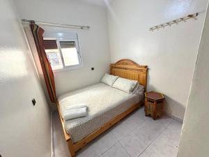 a small bedroom with a bed and a window at Beach House in Asilah +55 photos