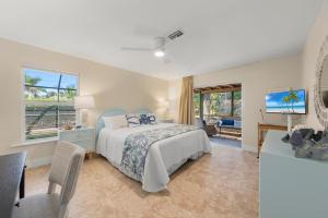 a bedroom with a bed and a view of the ocean at Tahitian Waters in Sanibel +53 photos