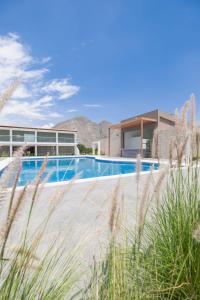 a swimming pool in front of a house at Centro Recreacional Simbal in Trujillo