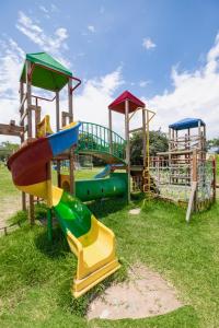 a group of playground equipment in the grass at Centro Recreacional Simbal in Trujillo
