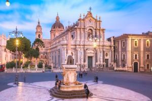 a large building with a statue in front of it at Moonlight Etna B&B Catania in Catania