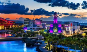 a city lit up at night with purple lights at The Wave Hotel Condado in San Juan