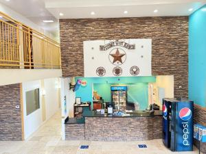 a fast food restaurant with a brick wall at Alien Residence Inn in Pecos