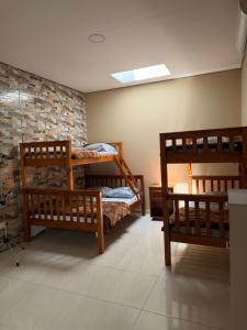 a room with two bunk beds and a brick wall at Recanto da Ivete in São Sebastião +58 photos