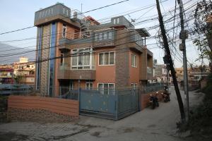 a building with a fence in front of it at Pepa's villa and homestay in Khadkagaon