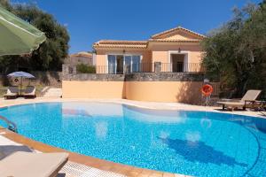 a swimming pool in front of a villa at Villa Odyssey Verde in Dassia