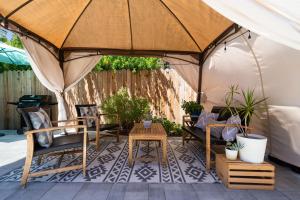 a patio with a tent with chairs and a table at Walk to Beach - Beach Gear - Easy Parking in Long Beach