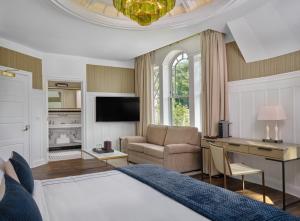 a bedroom with a bed and a desk and a couch at The Northport Hotel in Northport