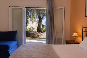 a bedroom with a bed and a sliding glass door at Villa Odyssey Verde in Dassia +35 photos