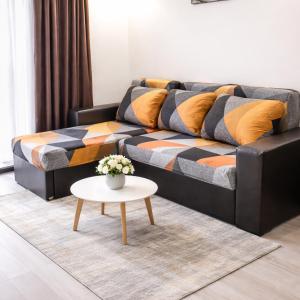 a living room with a couch and a table at The White Houses 7 in Nesebar