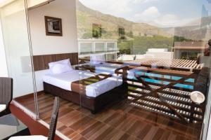 a room with a bed and a balcony with a pool at Centro Recreacional Simbal in Trujillo +22 photos