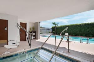 a swimming pool with a view of a house at Holiday Inn Express San Diego - Sea World Area by IHG in San Diego