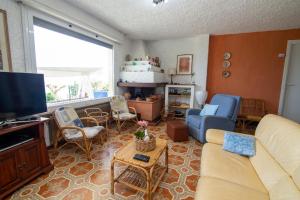a living room with a couch and a tv at Villa Ciacia in Cervo