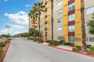 an empty street in front of a building with palm trees at Bluegreen Vacations Club 36, an Ascend Collection Resort in Las Vegas