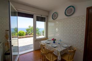 a dining room with a table and a view of the ocean at Villa Ciacia in Cervo