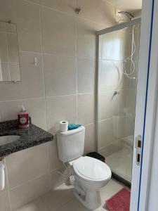 a bathroom with a toilet and a shower at Apto vista in Ponta Grossa +8 photos