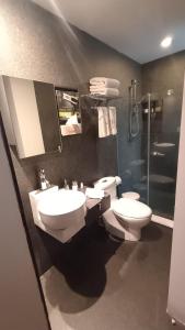 a bathroom with two toilets and a shower at Suites Aura For Living in Mexico City +18 photos
