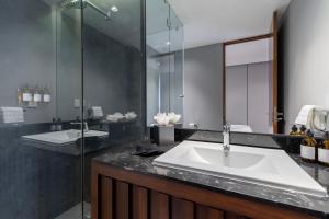 a bathroom with a sink and a glass shower at Capitalia Temistocles Polanco in Mexico City +46 photos