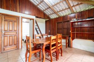 a dining room with a wooden table and chairs at Corcovado Green Cabin & House in Drake +52 photos