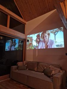 a living room with a couch and a flat screen tv at Dolina nad Drawa in Przeborowo