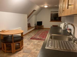 a kitchen with a sink and a counter top at Taighali Apartment in Aultbea
