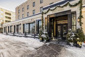 a store front with christmas trees outside of it at Hotel Port-Royal in Quebec City