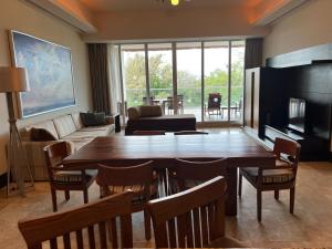 a living room with a wooden table and a living room with a fireplace at luxury 2bed condo in Nuevo Vallarta