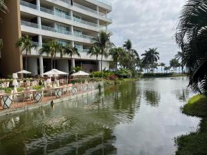 a hotel with a river in front of a building at luxury 2bed condo in Nuevo Vallarta