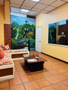 a room with a large painting on the wall at Yellow Belly Backpackers in San Ignacio