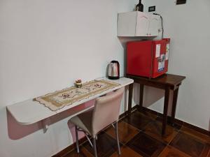 a small kitchen with a table and a microwave at Posada Oporto in La Rioja