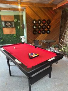 a pool table in a yard with wine bottles at Yellow Belly Backpackers in San Ignacio +42 photos