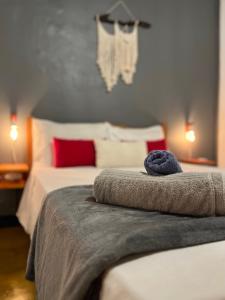 a bedroom with two beds with red and white pillows at Caju com Mel Hospedagem in Moreré