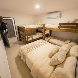 a room with four bunk beds in it at Apartaestudios Galanni in Valledupar +12 photos