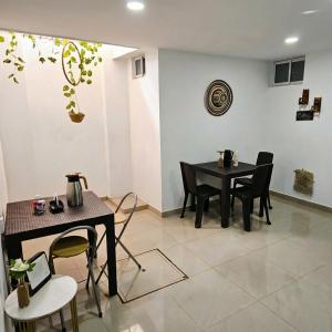 a dining room with two tables and chairs at Apartaestudios Galanni in Valledupar