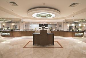 a large lobby with a bar in the middle at Hilton Prague Atrium in Prague