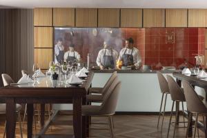 a group of men standing at a counter in a restaurant at Hilton Prague Atrium in Prague