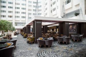a lobby of a hotel with tables and chairs at Hilton Prague Atrium in Prague +94 photos